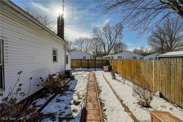 yard layered in snow featuring central AC