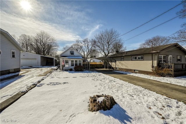 view of front of property featuring a carport and a garage