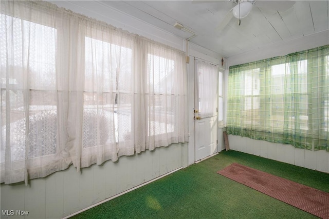 unfurnished sunroom with a wealth of natural light and ceiling fan