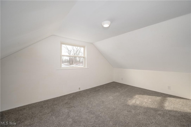 bonus room featuring lofted ceiling and carpet