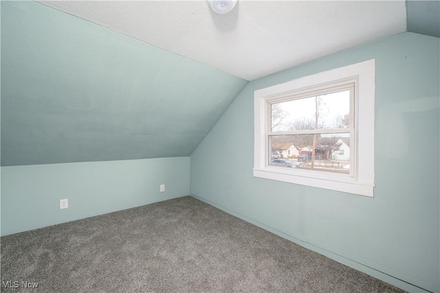 bonus room featuring vaulted ceiling and carpet flooring