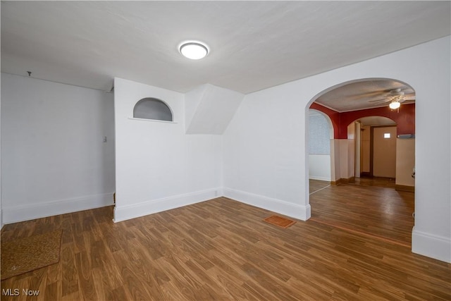 empty room with dark hardwood / wood-style flooring and ceiling fan