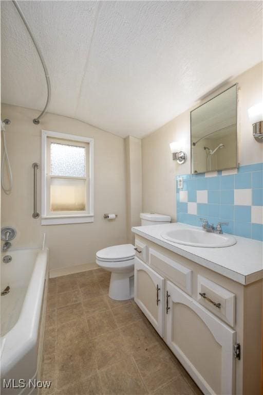 full bathroom featuring lofted ceiling, decorative backsplash, vanity, toilet, and a textured ceiling