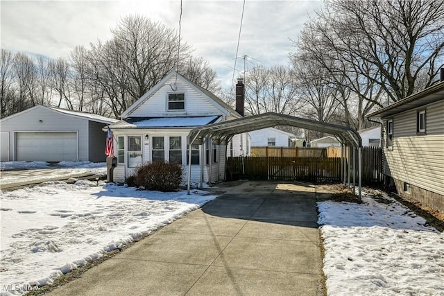 view of front of house with a carport, a garage, and an outdoor structure