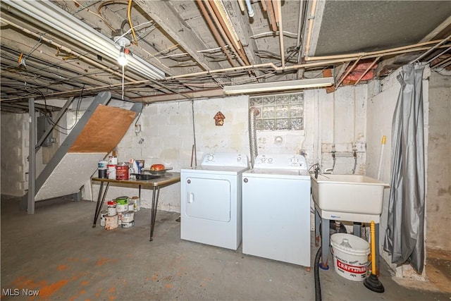 basement featuring sink and independent washer and dryer