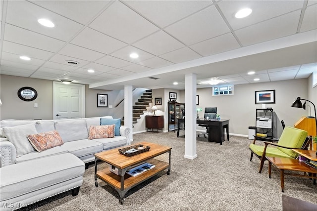 carpeted living room with a drop ceiling