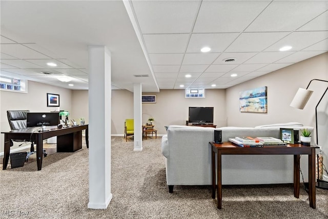 carpeted living room featuring a wealth of natural light and a paneled ceiling