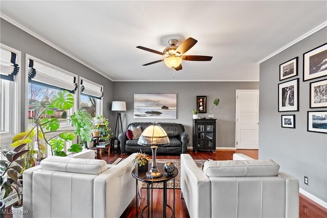 living room featuring ornamental molding, dark wood-type flooring, and ceiling fan