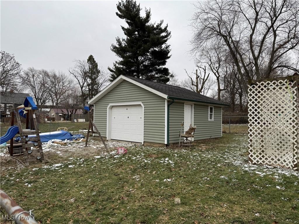 garage featuring a lawn