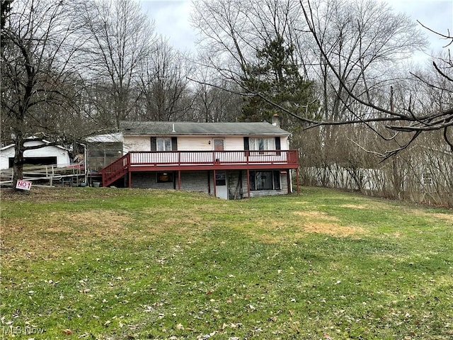 back of property featuring a yard and a deck