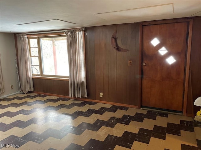 foyer with wooden walls