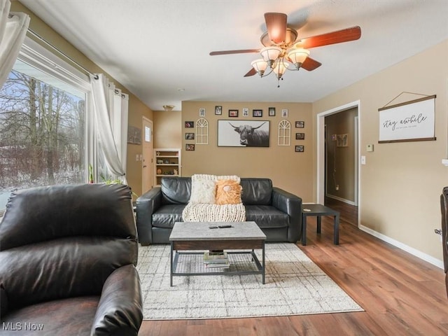 living room featuring hardwood / wood-style flooring and ceiling fan