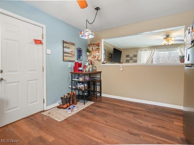 dining room with wood-type flooring and ceiling fan