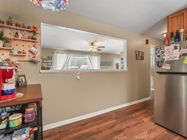 kitchen featuring hardwood / wood-style flooring, stainless steel fridge, and ceiling fan