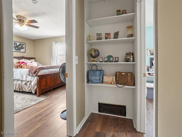 bedroom featuring wood-type flooring and a textured ceiling