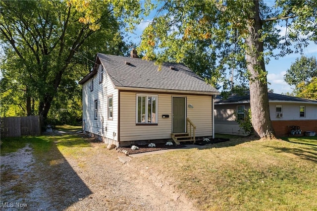 rear view of house featuring a yard