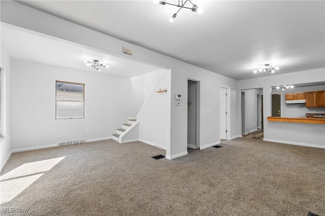 unfurnished living room featuring carpet flooring