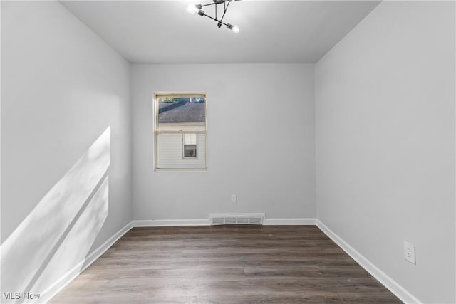 spare room with dark hardwood / wood-style floors