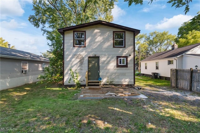 rear view of house featuring a lawn