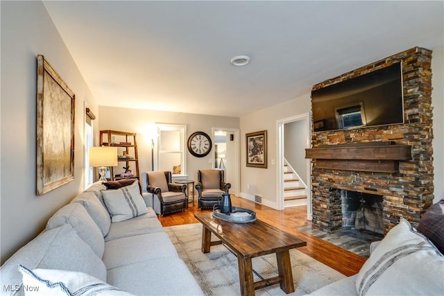 living room featuring a fireplace and light wood-type flooring