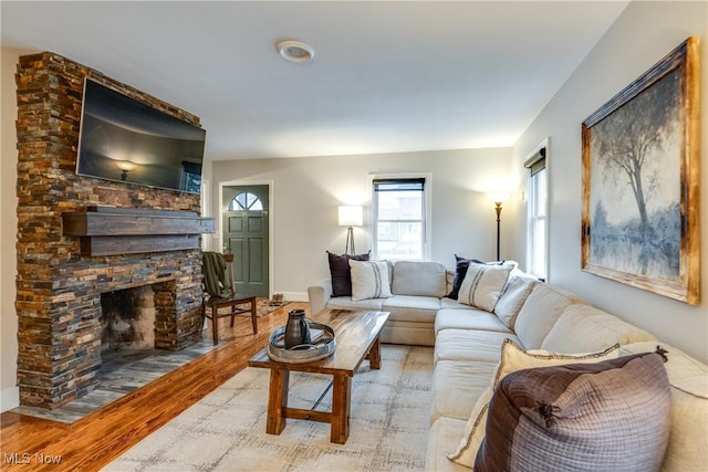 living room featuring a fireplace and light hardwood / wood-style flooring