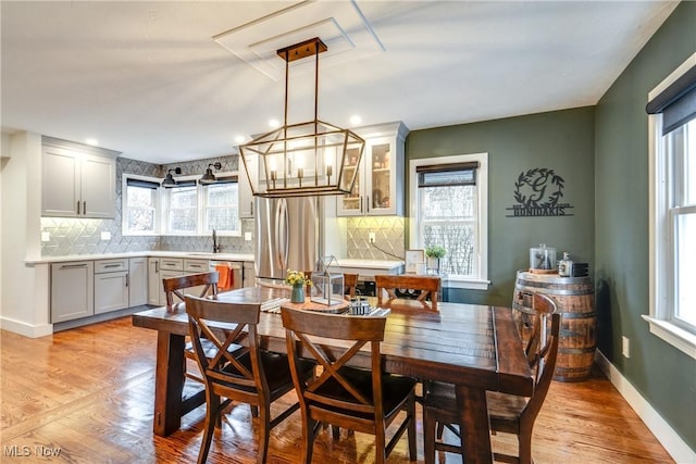 dining area with light hardwood / wood-style floors and sink