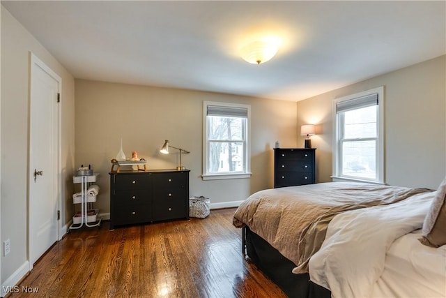 bedroom with dark hardwood / wood-style flooring