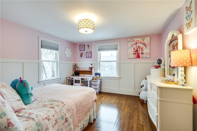 bedroom featuring dark wood-type flooring and multiple windows