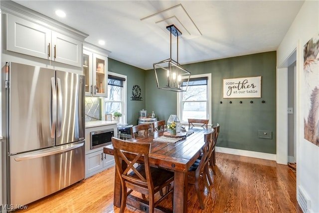 dining space featuring a notable chandelier and light hardwood / wood-style floors