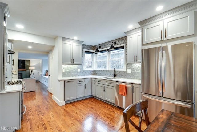 kitchen featuring light wood-type flooring, sink, gray cabinets, and appliances with stainless steel finishes