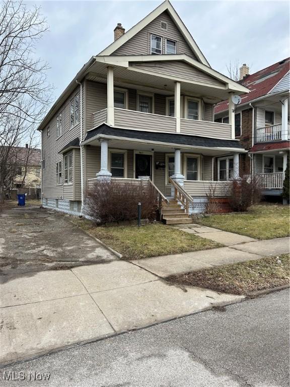 view of front of property featuring a balcony and covered porch