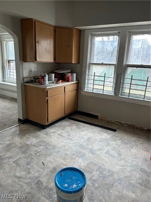 kitchen with decorative backsplash and plenty of natural light