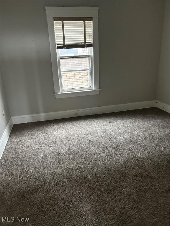 carpeted spare room with a healthy amount of sunlight