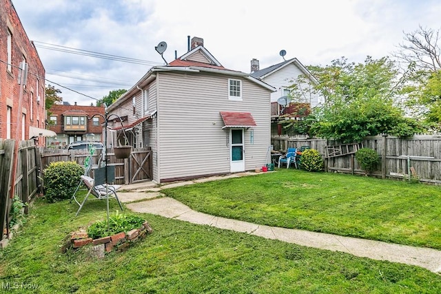 rear view of house with a lawn