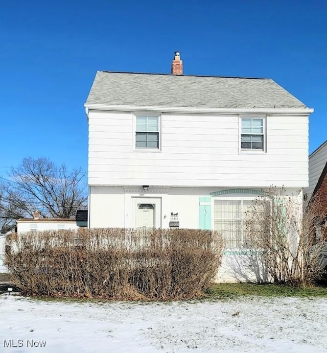 view of snow covered rear of property