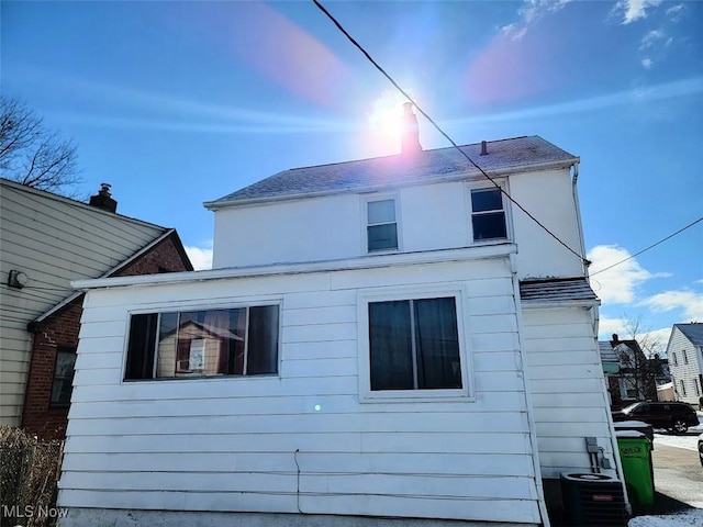 property exterior at dusk with central AC unit