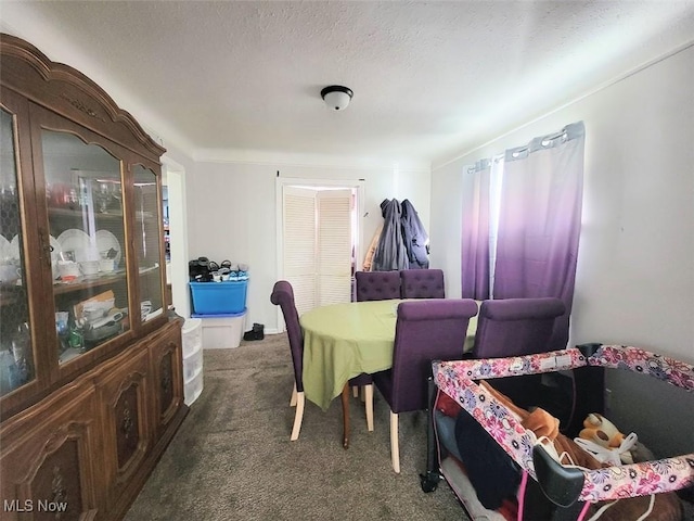 dining space with dark carpet and a textured ceiling