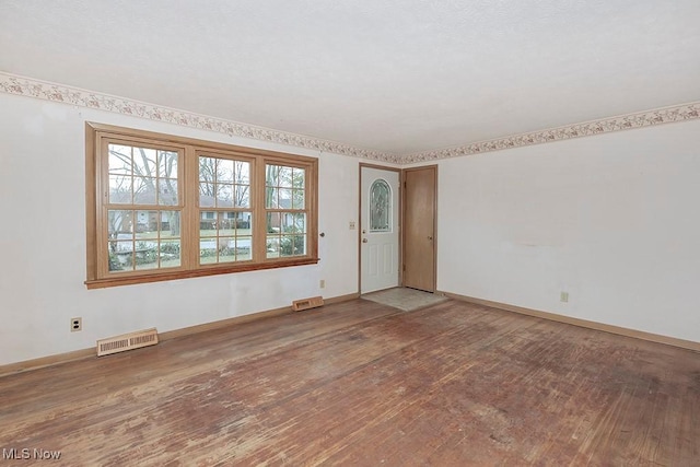 empty room with wood-type flooring