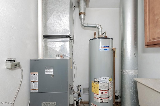 utilities with heating unit, sink, and gas water heater