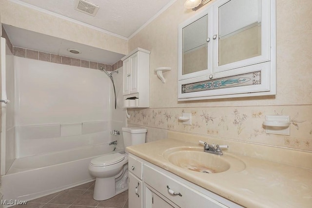 full bathroom featuring washtub / shower combination, tile patterned floors, toilet, vanity, and ornamental molding