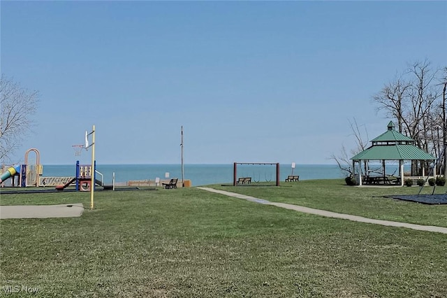 view of community with a yard, a gazebo, a playground, and a water view