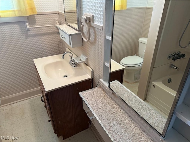 full bathroom featuring vanity, tub / shower combination, tile patterned floors, and toilet