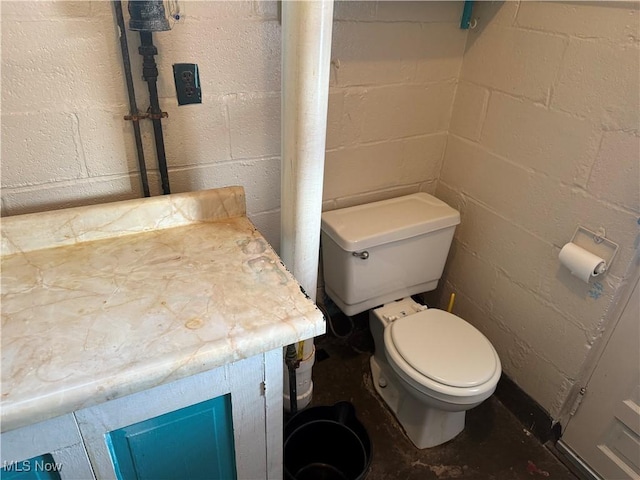 bathroom with concrete flooring and toilet