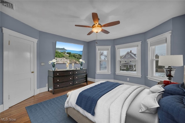 bedroom featuring dark hardwood / wood-style floors and ceiling fan