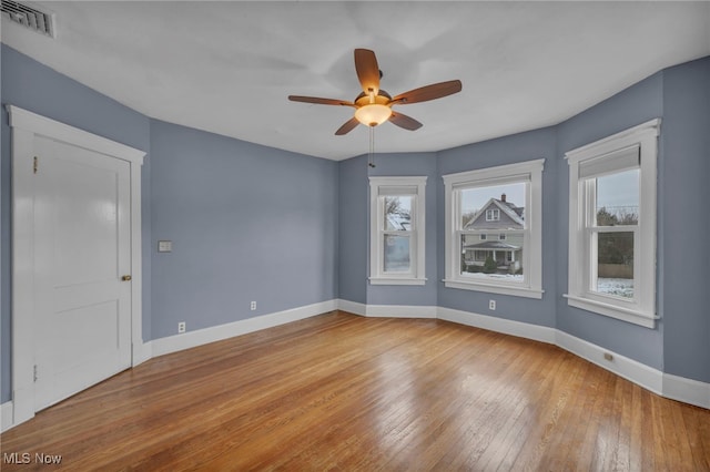 unfurnished room featuring ceiling fan, light hardwood / wood-style floors, and a wealth of natural light