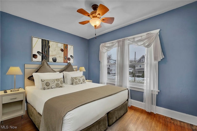 bedroom with hardwood / wood-style flooring and ceiling fan