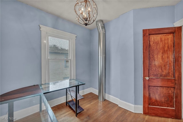 office area featuring an inviting chandelier and light hardwood / wood-style flooring