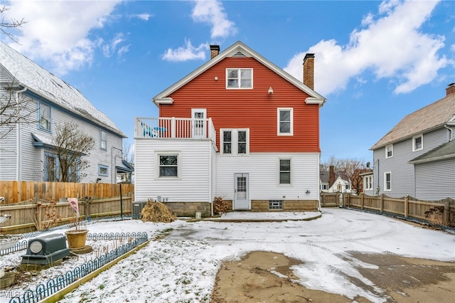 snow covered property with central AC unit