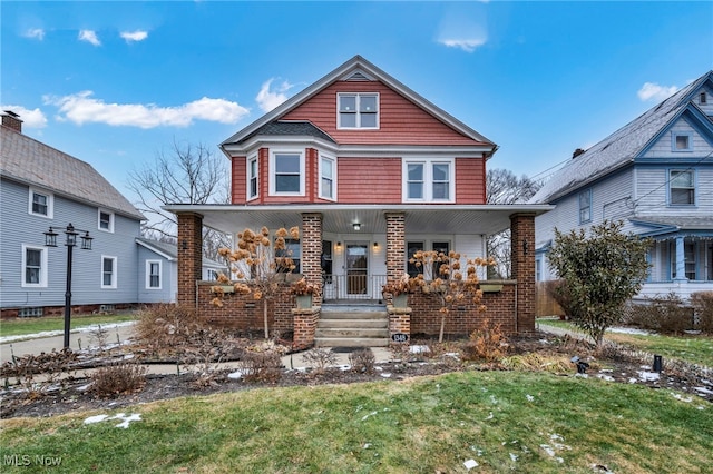 front facade featuring a front yard and a porch