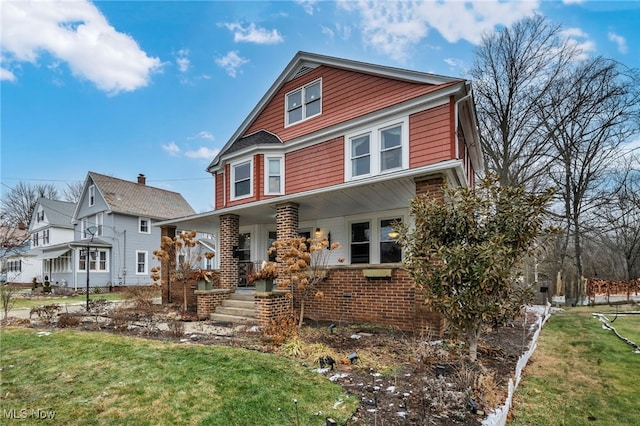 view of front of house featuring covered porch and a front lawn